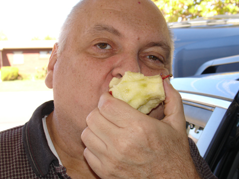 Grandpa Codella enjoying a freshly picked apple.